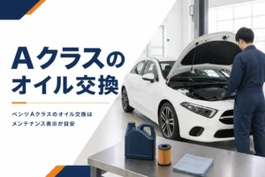 ボンネットを開けたハッチバックとオイル缶、オイルフィルターの並ぶ作業台