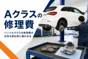 整備工場で点検中のハッチバックと、作業台に並んだブレーキパッドなどの部品